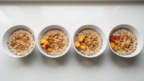 Four bowls of the same oatmeal breakfast in a row, each with a slightly larger serving